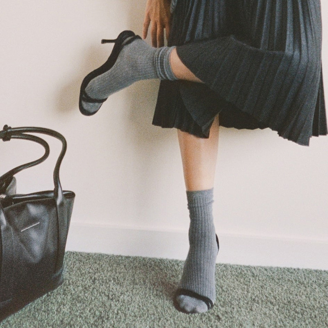 Woman's legs wearing grey cashmere socks